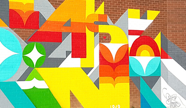 Graffiti-style mural with bold typography and character illustrations